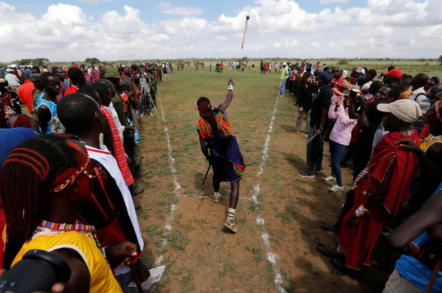 A Maasai moran throws a traditional club, known as rungu, during the 2016 Maasai Olympics at the Sidai Oleng Wildlife Sanctuary, at the base of Mt. Kilimanjaro, near the Kenya-Tanzania border in Kimana, Kajiado, Kenya December 10, 2016. (Photo by Thomas Mukoya/Reuters)