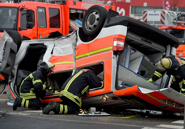 A toppeled ambulance vehicle that has been wrecked in an accident when it collided with another car during an emergency operation, in Kiel, Germany, 25 January 2016. Imediate information on the cause of the accident and the severity of the injuries were unavailable. (Photo by Carsten Rehder/EPA)