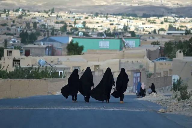 Women walk through a road in Ghazni on June 3, 2021. (Photo by Wakil Kohsar/AFP Photo)