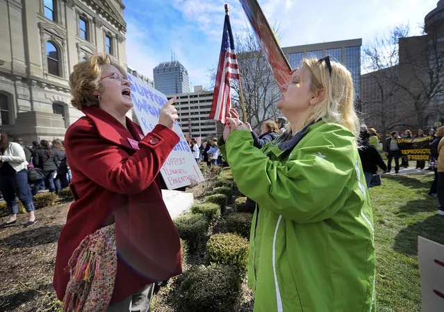 In this Tuesday, March 8, 2011 file photo, Planned Parenthood supporter Peg Paulson of Carmel, Ind., left, and opponent Heather Pruett of Indianapolis argue during a rally at the Indiana Statehouse on the South Lawn in Indianapolis in response to an Indiana House bill which would end funding to Planned Parenthood because it provides abortions. The nation's leading breast-cancer charity, Susan G. Komen for the Cure, is halting its partnerships with Planned Parenthood affiliates in 2012 - creating a bitter rift, linked to the abortion debate, between two iconic organizations that have assisted millions of women. Planned Parenthood says the cutoff, primarily affecting grants for breast exams, results from Komen bowing to pressure from anti-abortion activists. Komen says the key reason is that Planned Parenthood is under investigation in Congress - a probe launched by a conservative Republican who was urged to act by anti-abortion groups. (Photo by Alan Petersime/AP Photo/The Indianapolis Star)