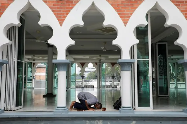 A Muslim prays on the first Friday of the holy fasting month of Ramadan, amid the coronavirus disease (COVID-19) pandemic, in Kuala Lumpur, Malaysia, April 16, 2021. (Photo by Lim Huey Teng/Reuters)