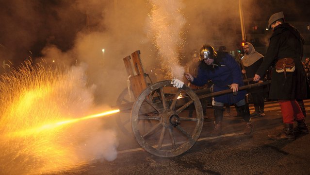 Tradition-keepers fire a cannon during the New Year's Eve celebrations in Hajduszoboszlo, 207 kms east of Budapest, Hungary, 31 December 2016. (Photo by Zsolt Czegledi/EPA)