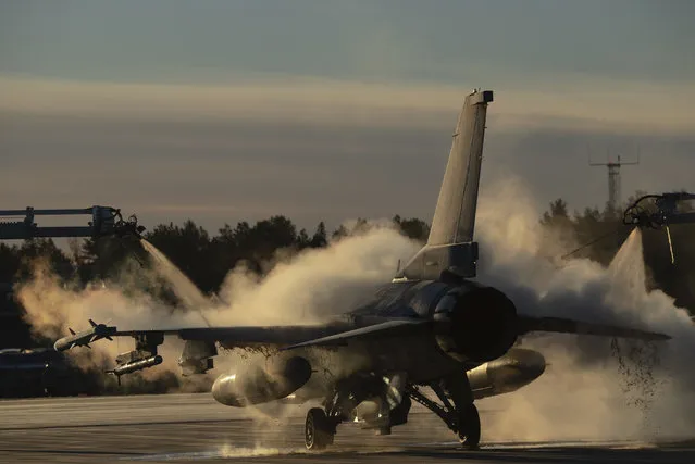 A handout photo made available by the US Air Force shows a US Air Force F-16 Fighting Falcon assigned to the 480th Expeditionary Fighter Squadron being de-iced in preparation of the NATO military exercise Trident Juncture 18, at Kallax Air Base, Sweden, 24 October 2018. According to reports, some 50,000 participants from over 30 nations are expected to take part in the NATO-led military exercise in Norway from 25 October to 23 November 2018. (Photo by Lt Casey D. Rodriguez/EPA/EFE)