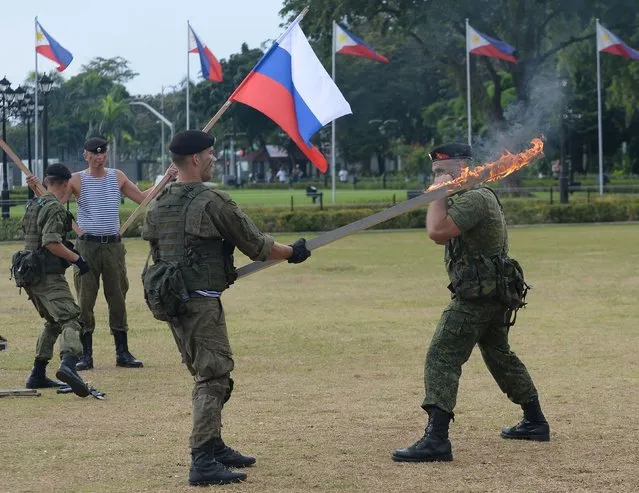 Russian marines attached to the anti- submarine ship Admiral Tributs show their skills during a demonstration at a park in Manila on January 5, 2017, as part of their five- day port- of- call activities in the country' s capital The Russian Navy said on January 3 it was planning to hold war games with the Philippines, as two of its ships made a rare stop in Manila following Filipino President Rodrigo Duterte' s pivot from the United States. (Photo by Ted Aljibe/AFP Photo)