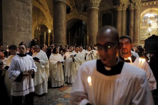 Members of the Catholic clergy hold candles during Easter procession in the Church of the Holy Sepulchre in Jerusalem's Old City April 5, 2015. (Photo by Ammar Awad/Reuters)