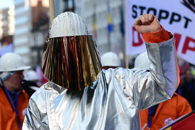 A steel worker gestures as he takes part in a protest to demand urgent action against cheap Chinese imports, in front of the European Commission in Brussels on February 15, 2016. About 5 000 protesters asked the European Commission to ramp up tariffs on China to stop the dumping cut-price. (Photo by Emmanuel Dunand/AFP Photo)