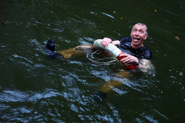 Swedish geneticist Svante Paabo, who won the 2022 Nobel Prize in Physiology or Medicine for discoveries that underpin our understanding of how modern day humans evolved from extinct ancestors, reacts after being thrown into the water by co-workers, at the Max-Planck Institute for evolutionary anthropology in Leipzig, Germany on October 3, 2022. (Photo by Lisi Niesner/Reuters)