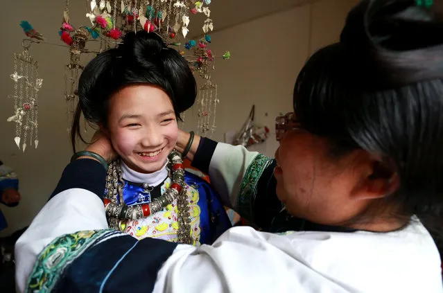 A young girl prepares for Chixiangsi, a folk custom where youngsters from different villages dress up, dance and look for love in Guizhou province, China on February 19, 2016. (Photo by Xinhua/Barcroft Media)