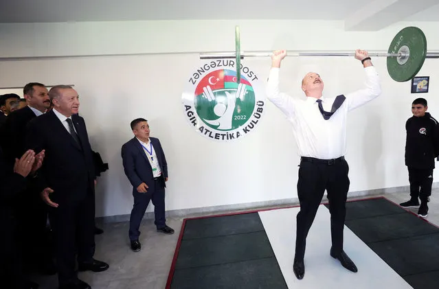 Azerbaijan's President Ilham Aliyev lifts weights as Turkey's President Tayyip Erdogan looks on during their visit at a sports club near the city of Zangilan, recaptured by Azerbaijani forces from the ethnic Armenians in 2020 during the military conflict in the breakaway region of Nagorno-Karabakh on October 20, 2022. (Photo by Presidential Press Office/Handout via Reuters)