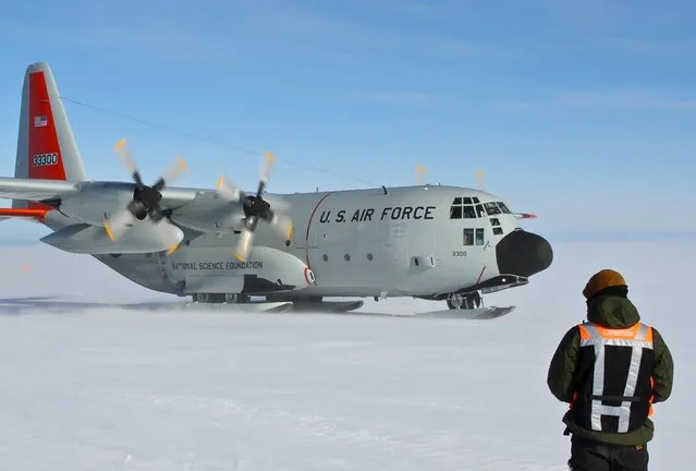 A U.S Air Force LC-130 Hercules taxis before taking off at Davis Research Station in Antarctica in this January 15, 2015 handout picture supplied by the Australian Antarctic Division on February 26, 2016. An LC-130 will now move more than 30 expeditioners who were waiting to return home aboard the icebreaker Aurora Australis, which has run aground at Mawson Station, according to a statement from the Australian Antarctic Division. (Photo by Reuters/Australian Antarctic Division)