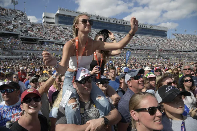 Fans watch as Jake Owen performs before a NASCAR Daytona 500 auto race at Daytona International Speedway, Sunday, February 17, 2019, in Daytona Beach, Fla. (Photo by Phelan M. Ebenhack/AP Photo)