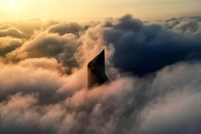 This aerial view shows Kuwait City's al-Hamra tower caught in heavy fog on November 17, 2023. (Photo by Yasser al-Zayyat/AFP Photo)