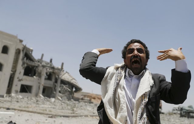 A Houthi militant reacts at the yard of the residence of the military commander of the Houthi militant group, Abdullah Yahya al Hakim, after an air strike destroyed it, in Sanaa April 28, 2015. (Photo by Khaled Abdullah/Reuters)