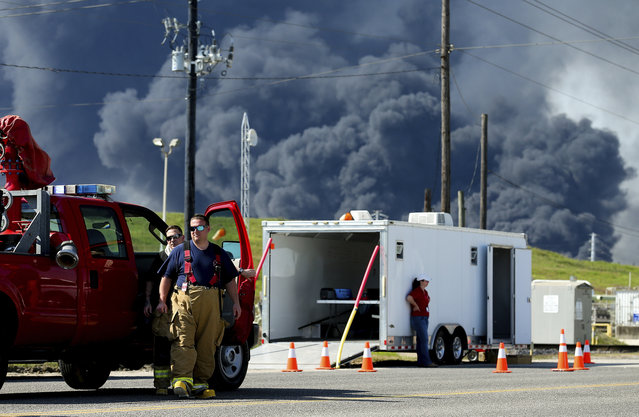 Firefighters arrive at the site where the Intercontinental Terminals Company petrochemical fire reignited, Friday, March 22, 2019, in Deer Park, Texas. The efforts to clean up a Texas industrial plant that burned for several days this week were hamstrung Friday by a briefly reignited fire and a breach that led to chemicals spilling into the nearby Houston Ship Channel. (Photo by Godofredo A. Vasquez/Houston Chronicle via AP Photo)