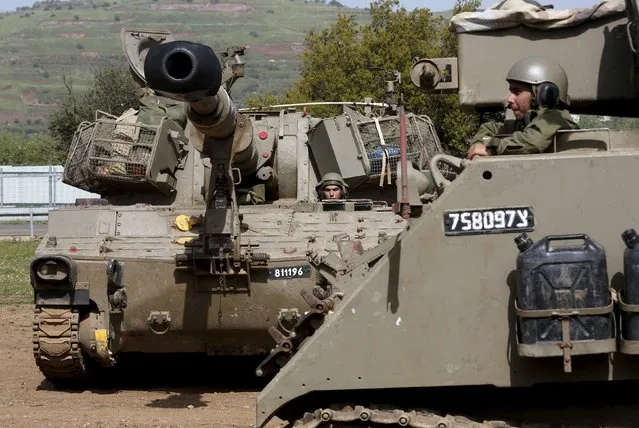 An Israeli soldier is seen in a mobile artillery unit in the Druze village of Buqata in the Golan Heights April 27, 2015. An Israeli air strike killed four militants on Sunday as they placed an explosive on a fence near Israel's frontier with Syria in the annexed Golan Heights, an Israeli military source said. (Photo by Baz Ratner/Reuters)