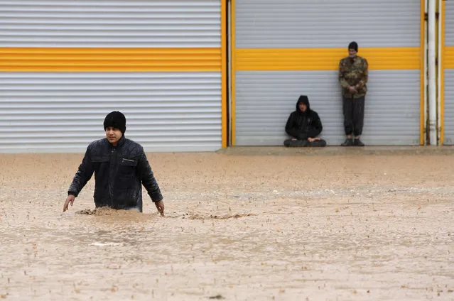 In this Monday, April 1, 2019 photo, a man crosses a flooded street in the city of Khorramabad in western province of Lorestan, Iran. Iran's Foreign Minister Mohammad Javad Zarif tweeted late on Monday that U.S. sanctions imposed on Tehran by the Trump administration last year have hampered successful rescue efforts for flood-stricken areas of the country where 45 people have died so far. Iran has been facing major flooding for the past two weeks. (Photo by Saeed Soroush/AP Photo/Tasnim News Agency)