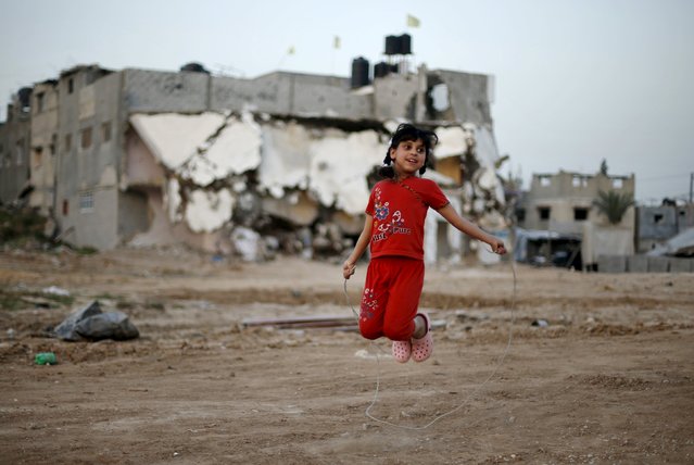 A Palestinian girl plays in front of her family's house that witnesses said was destroyed by Israeli shelling during a 50-day war last summer, in the east of Gaza City April 27, 2015. (Photo by Mohammed Salem/Reuters)