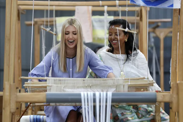 White House senior adviser Ivanka Trump, left, reacts as she tries her hand at a traditional weaving loom at Muya, a manufacturing center of textile and traditional crafts, with Muya founder Sara Abera, Sunday, April 14, 2019, in Addis Ababa, Ethiopia. Trump is visiting Ethiopia and later this week the Ivory Coast to promote a White House global economic program for women. (Photo by Jacquelyn Martin/AP Photo)