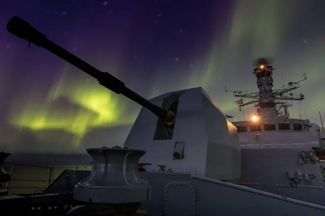 The aurora borealis above HMS Lancaster during a two-week solo patrol of the Arctic on September 28, 2021. The Portsmouth-based frigate ventured into the frozen wastes on a 3,000-mile round-trip into the Arctic Circle. (Photo by Kyle Heller/PA Wire Press Association)
