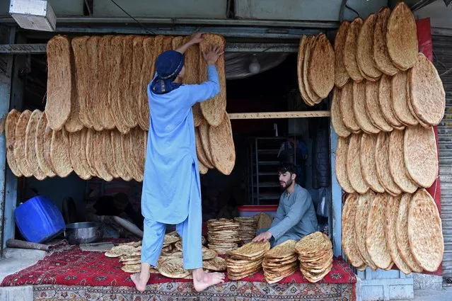 Vendors selling bread wait for customers at a roadside hotel in Quetta on March 25, 2024. (Photo by Banaras Khan/AFP Photo)