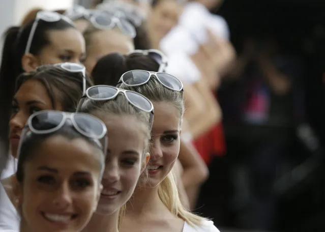 Models queue to enter for rehearsals on the starting grid after the qualifying session at the Monaco racetrack, in Monaco, Saturday, May 23, 2015. The Formula one race will be held on Sunday. (Photo by Luca Bruno/AP Photo)