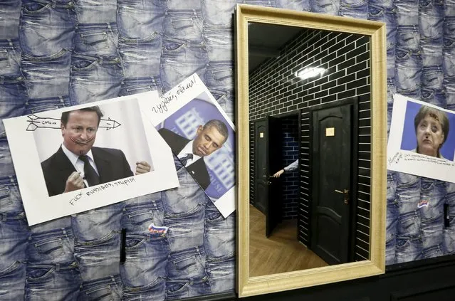 A visitor closes the toilet door as portraits of foreign leaders are seen on a wall at the “President Cafe” in Krasnoyarsk, Siberia, Russia, April 7, 2016. (Photo by Ilya Naymushin/Reuters)