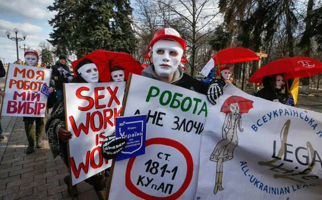 Masked protesters carry banners reading s*x work is my work! , My work is my choice! and others during their rally in front of Parliament building in Kiev, Ukraine, 03 March 2017. Ukrainian s*x workers and activists who support them demand to dismiss liability for prostitution and legalization of it. (Photo by Sergey Dolzhenko/EPA)