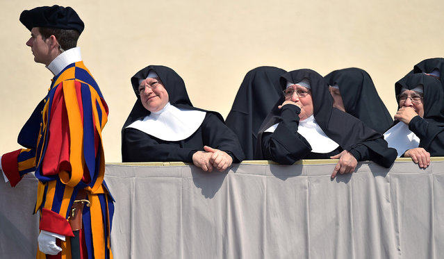 Nuns stand at St. Peter's square at the Vatican at the end of the Pope's weekly general audience on April 2, 2014. (Photo by Gabriel Bouys/AFP Photo)