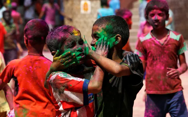 Boys smear each other with colors during Holi, the Festival of Colours, celebrations in Kolkata, India, March 11, 2017. (Photo by Rupak De Chowdhuri/Reuters)