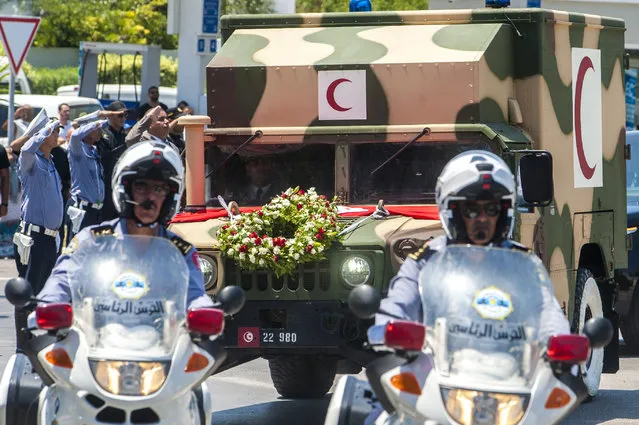 The convoy carrying the body of Tunisian President Beji Caid Essebsi leaves the military hospital in Tunis, Tunisia, Friday, July 26, 2019. Tunisia is inviting world leaders to attend the funeral for its president who died in office and preparing a new election to replace him. The next election was originally set for Nov. 17, but is being rescheduled after President Beji Caid Essebsi died in office Thursday at 92. (Photo by Hassene Dridi/AP Photo)