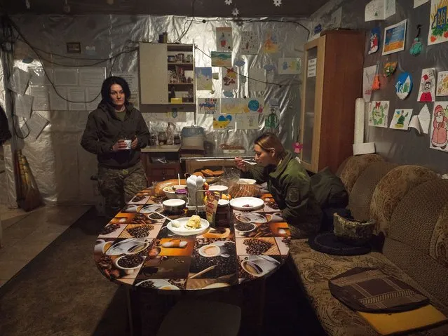 Ukrainian army press officer Alena (R), 32, and Sgt. Natacha take a break in the dining room on February 9, 2022 in Pisky, Ukraine. Tensions between the NATO military alliance and Russia are intensifying due to Russia's move of tens of thousands of troops as well as heavy weapons to the Ukrainian border, causing international fears of a possible Russian invasion of Ukraine. (Photo by Gaelle Girbes/Getty Images)