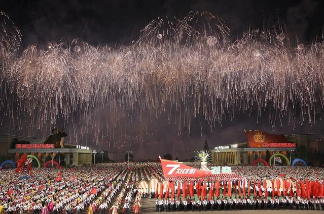 Fireworks explode over the Kim Il Sung Square during a parade on Tuesday, May 10, 2016, in Pyongyang, North Korea. Hundreds of thousands of North Koreans celebrated the country's newly completed ruling-party congress Tuesday with a massive civilian parade featuring floats bearing patriotic slogans and marchers with flags and pompoms, and celebrations followed on into the evening with a torchlight parade and mass dance party by youths. (Photo by Wong Maye-E/AP Photo)