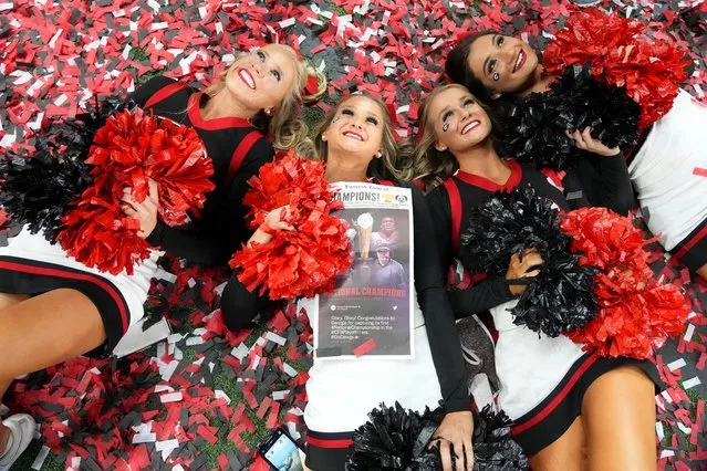 Georgia Bulldogs cheerleaders celebrate on a confetti-covered field after defeating the Alabama Crimson Tide in the 2022 CFP college football national championship game at Lucas Oil Stadium in Indianapolis, Indiana, January 10, 2022. (Photo by Kirby Lee/USA TODAY Sports)