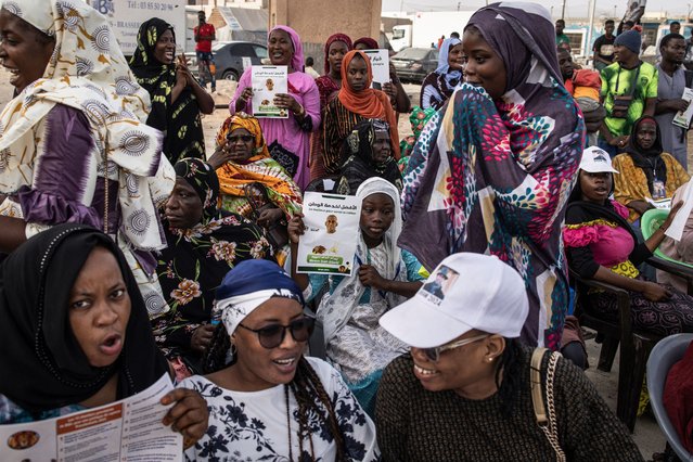 Supporters of opposition leader, Biram Dah Abeid hold up campaign posters at a rally in Nouakchott on June 25, 2024. The vast desert country in West Africa, will vote on June 29 for the presidential election. The former French colony, independent since 1960, experienced a succession of coups from 1978 to 2008, before the 2019 election - won by ex-general Mohamed Ould Cheikh El Ghazouani, who is seeking a second term the 29th - marks the first transition between two elected presidents. (Photo by John Wessels/AFP Photo)