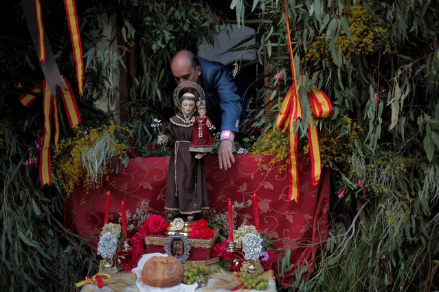A man decorates an altar outside a house during Corpus Christi day in Zahara de la Sierra, southern Spain, May 29, 2016. (Photo by Jon Nazca/Reuters)