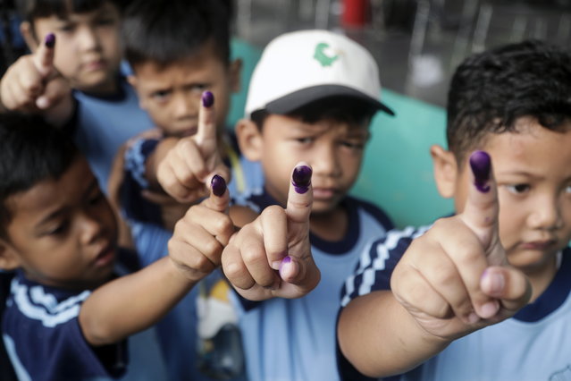 Children show their inked-marked fingers after receiving a dose of bivalent oral polio vaccine (bOPV) during the first phase of mass polio vaccination week in Jakarta, Indonesia, 25 July 2024. According to the World Health Organization (WHO), Indonesia is categorized as a high risk area for polio transmission with a total of 32 provinces and 399 districts or cities included in the high risk category. (Photo by Bagus Indahono/EPA)