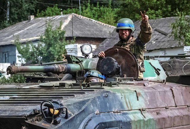 Ukrainian servicemen ride a BMP-1 infantry fighting vehicle, amid Russia's attack on Ukraine, near the Russian border in Sumy region, Ukraine on August 10, 2024. (Photo by Viacheslav Ratynskyi/Reuters)