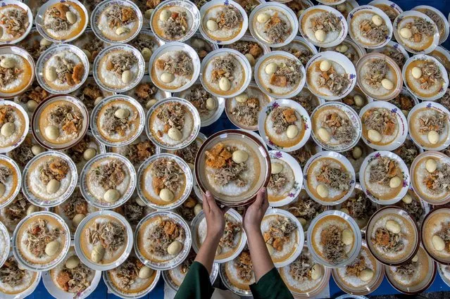 A woman prepares food for iftar, the fast breaking meal, during the holy month of Ramadan at a mosque in Yogyakarta, Indonesia, April 8, 2022. (Photo by Xinhua News Agency/Rex Features/Shutterstock)