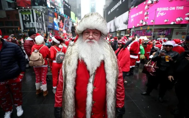 People dress up as Santa Clause on SantaCon day at Times Square in New York, United States on December 14, 2019. Santacon began in San Francisco in 1994, inspired by a Mother Jones article on the Danish activist theatre group Solvognen. (Photo by Tayfun Coskun/Anadolu Agency via Getty Images)