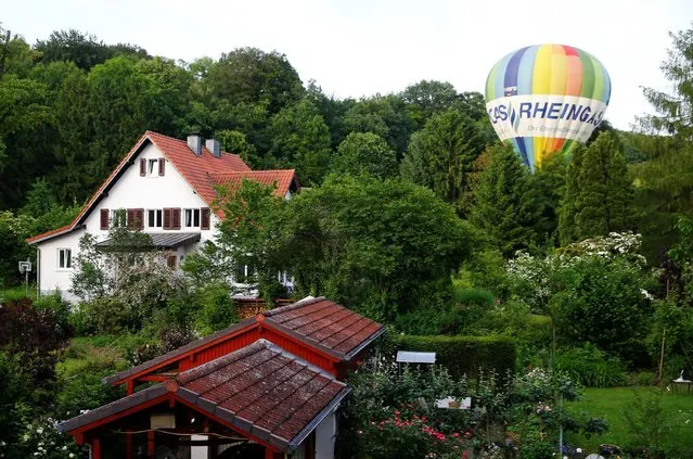 A balloon driver mistankingly lands in a garden in Bad Honnef near Bonn, western Germany June 10, 2016. (Photo by Wolfgang Rattay/Reuters)