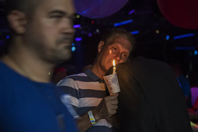 A gunmen opened fire in a gay nightclub in Orlando, Fla. early Sunday morning killing 50 people and wounding 53 more. It's being called the worst mass shooting in U.S. history. Bill McKinney, of Orlando, left, leans his head on friend Keith Andrews' shoulder during a candlelight vigil at the Parliament House, a gay-friendly resort and club in Orlando. McKinney was at Pulse with friends until about 1:15 am. “I never go there”, he said through tears. (Photo by Melissa Lyttle/The Washington Post)