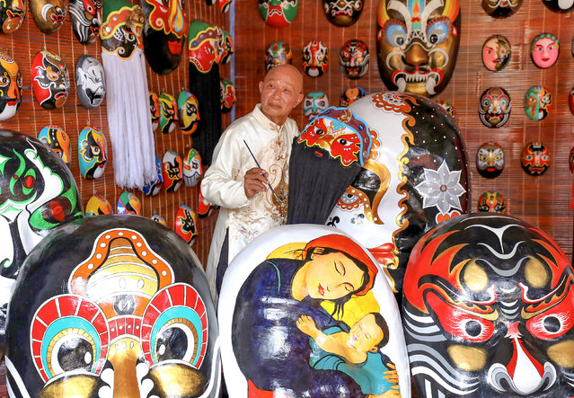 The artist Bui Quy Phong works on masks at his home in Hoi An, Vietnam in the first decade of September 2024. Paper masks are popular in Vietnamese culture, especially in mid-autumn festivals where they are traditional toys associated with the delight of childhood. (Photo by Sabina Akter/Solent News)