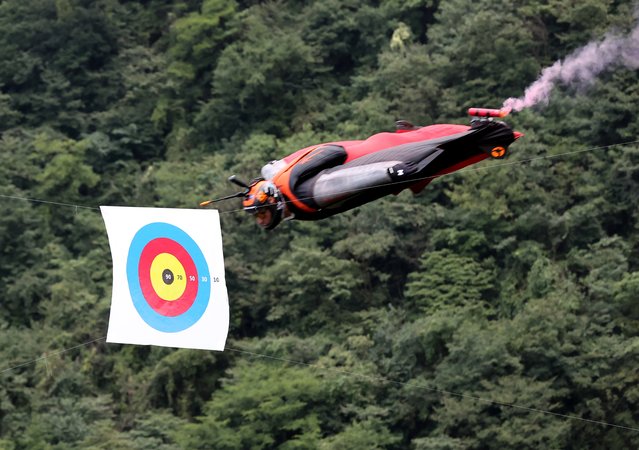 A participant competes in the tenth World Wingsuit League Wingsuit Flying World Championship at the Tianmen Mountain National Forest Park on September 17, 2024 in Zhangjiajie, Hunan province of China. The competition consists of two main components: speed race and flying through targets. (Photo by Zhou Guoqiang/VCG via Getty Images)