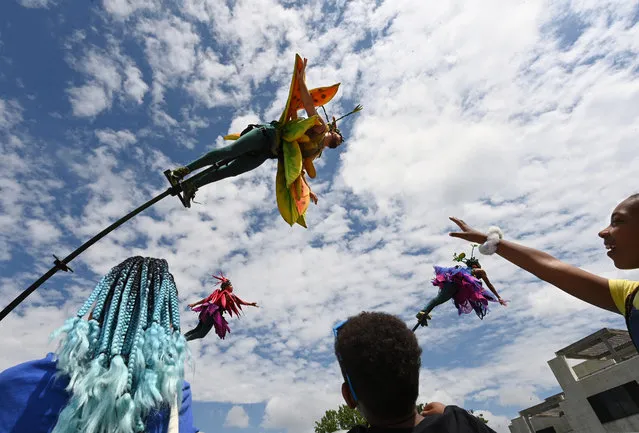 People gather to watch the Australian company, Sway perform Bloom! during Columbia Festival of the Arts Lakefest on Sunday June 12, 2022 in Columbia, MD. (Photo by Matt McClain/The Washington Post)