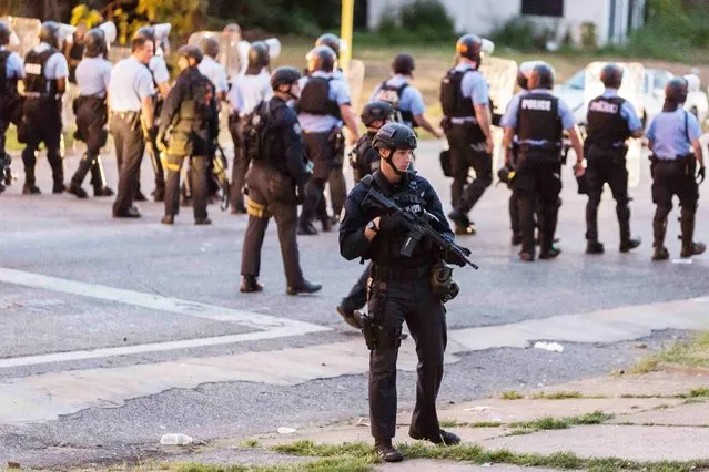 Police line up to block the street as protesters gathered after a shooting incident in St. Louis, Missouri August 19, 2015. (Photo by Kenny Bahr/Reuters)