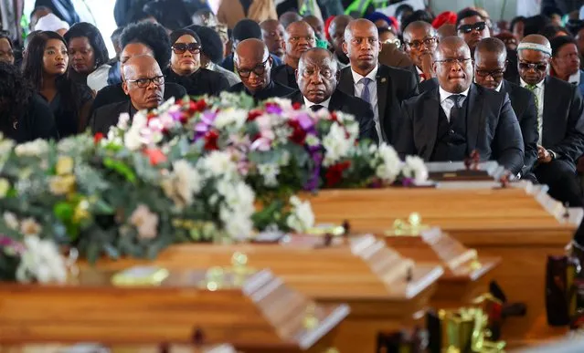 South African President Cyril Ramaphosa looks on as he joins mourners gathered in the coastal city of East London to grieve the still-mysterious deaths of 21 teenagers in a poorly ventilated local tavern, in East London, in the Eastern Cape province, South Africa, July 6, 2022. (Photo by Siphiwe Sibeko/Reuters)