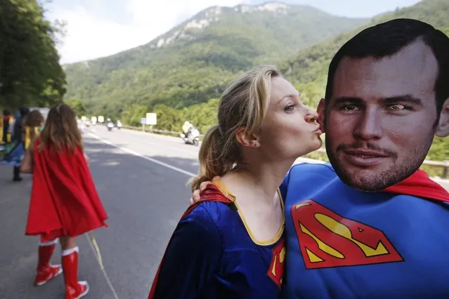 People dressed in Superman suits, one wearing a mask with the face of Britain's sprinter Mark Cavendish, wait for the pack to pass during the seventh stage of the Tour de France cycling race over 162.5 kilometers (100.7 miles) with start in L'Isle-Jourdain and finish in Lac de Payolle, France, Friday, July 8, 2016. (Photo by Christophe Ena/AP Photo)