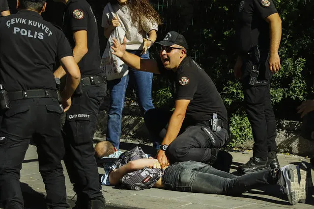 A man is detained during the LGBTQ Pride March in Ankara, Turkey, Tuesday, July 5, 2022. Police in Turkey’s capital have broken up a LGBTQ Pride march and detained dozens of people. Turkish authorities have banned LGBTQ events. (Photo by Ali Unal/AP Photo)