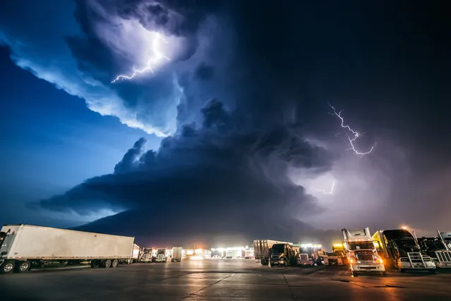 Amazing supercell storm during twilight nears a York Nebraska truck stop on I80 as it spits out lightning, June 17, 2009. Only a half hour or so earlier this storm was producing a long-lived large tornado near Aurora Nebraska. (Photo by Mike Hollingshead)