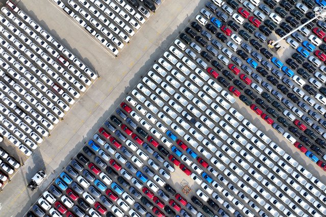 An aerial view shows cars and pickups on the dock waiting to be loaded onto ships for export at the port in Lianyungang, in China's eastern Jiangsu province on December 12, 2024. (Photo by AFP Photo/China Stringer Network)